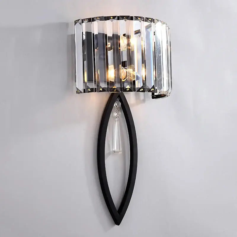 A sleek black metal decorbites crystal led wall lamp with curved frame and vertical crystal prisms for bedroom lighting