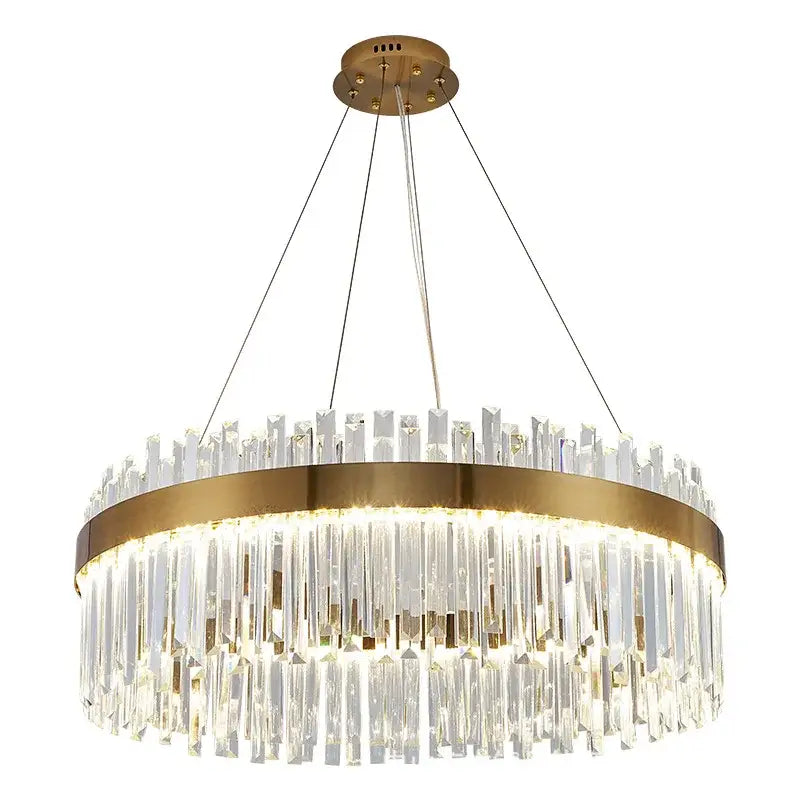 A modern decorbites crystal led chandelier with gold metal frame and cascading clear crystal prisms for dining room lighting