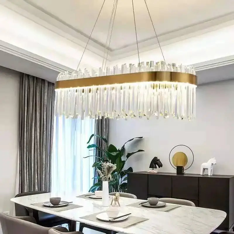 A modern gold metal oval decorbites crystal led chandelier with clear crystal prisms for dining room lighting
