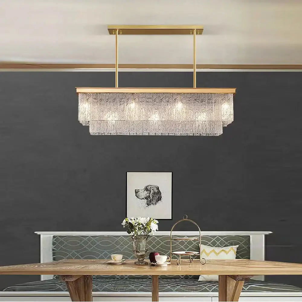 A decorbites crystal led gold rectangular chandelier with metal frame and cascading clear textured glass crystals for dining room