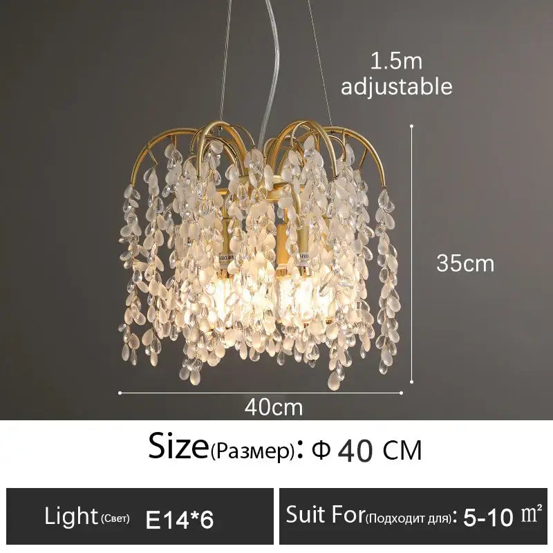 A delicate gold-toned decorbites crystal led chandelier with clear teardrop pendants for luxury living rooms