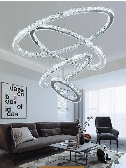 A modern chrome ring decorbites crystal led chandelier with interlocking circular rings and clear crystals for living room light