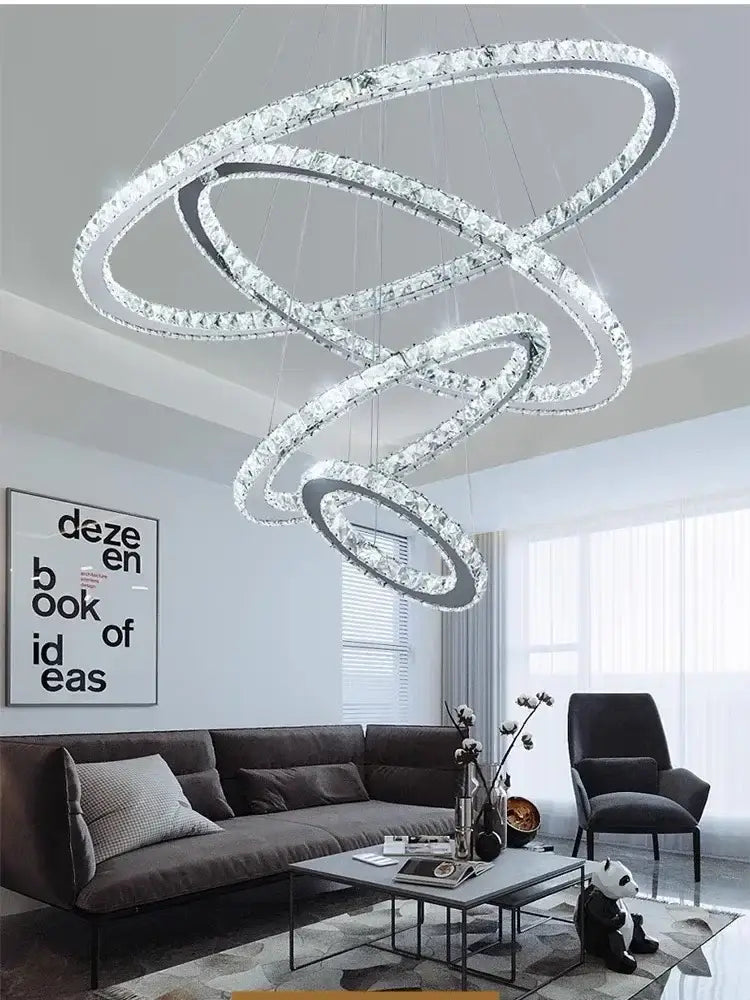 A modern chrome ring decorbites crystal led chandelier with interlocking circular rings and clear crystals for living room light