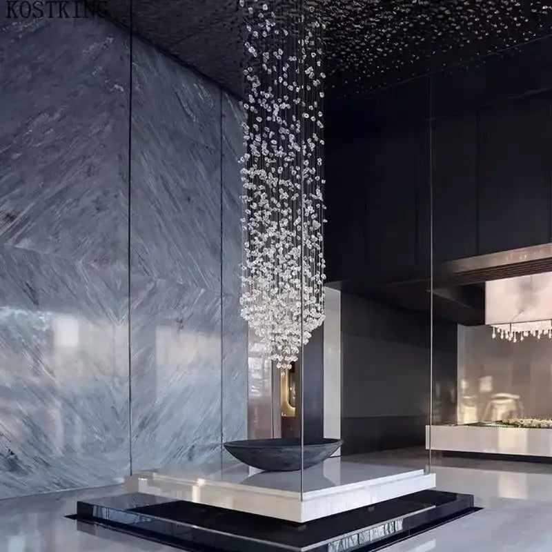 A cascading decorbites crystal led chandelier with clear faceted crystals for luxury staircase lighting
