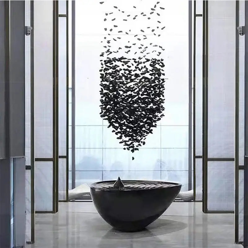 Black glossy ceramic bowl with central spout and concentric ridges in decorbites crystal led chandelier luxury lighting design