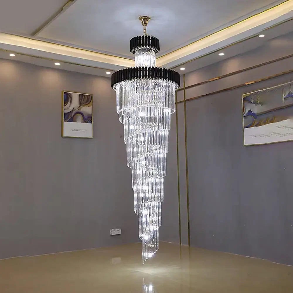 A modern decorbites crystal led multi-layer staircase chandelier with cascading crystal rods and a black metal frame
