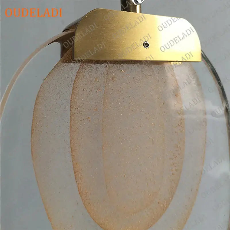 Gold-toned brass decorbites crystal led pendant with frosted translucent glass panels and subtle speckled texture for kitchen light