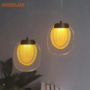 Two warm yellow decorbites crystal led pendant lights with frosted glass shades and metallic fixtures for kitchens