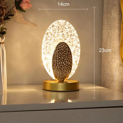 Gold-toned decorbites crystal led table lamp with textured illuminated shell and dark pebble design for bedroom décor