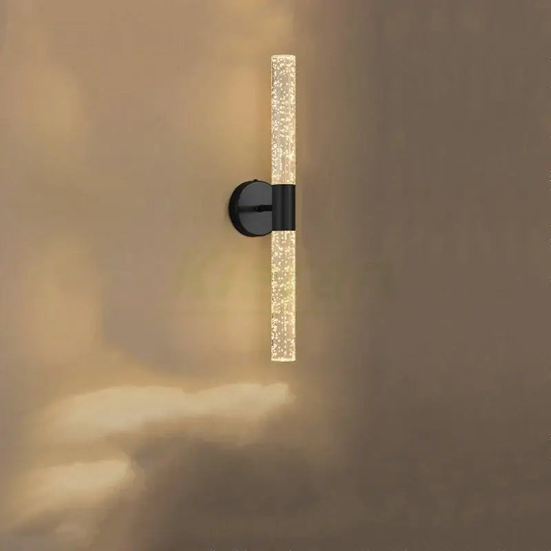A sleek black decorbites crystal led wall lamp with a translucent glass tube and warm ambient glow for bedroom decor