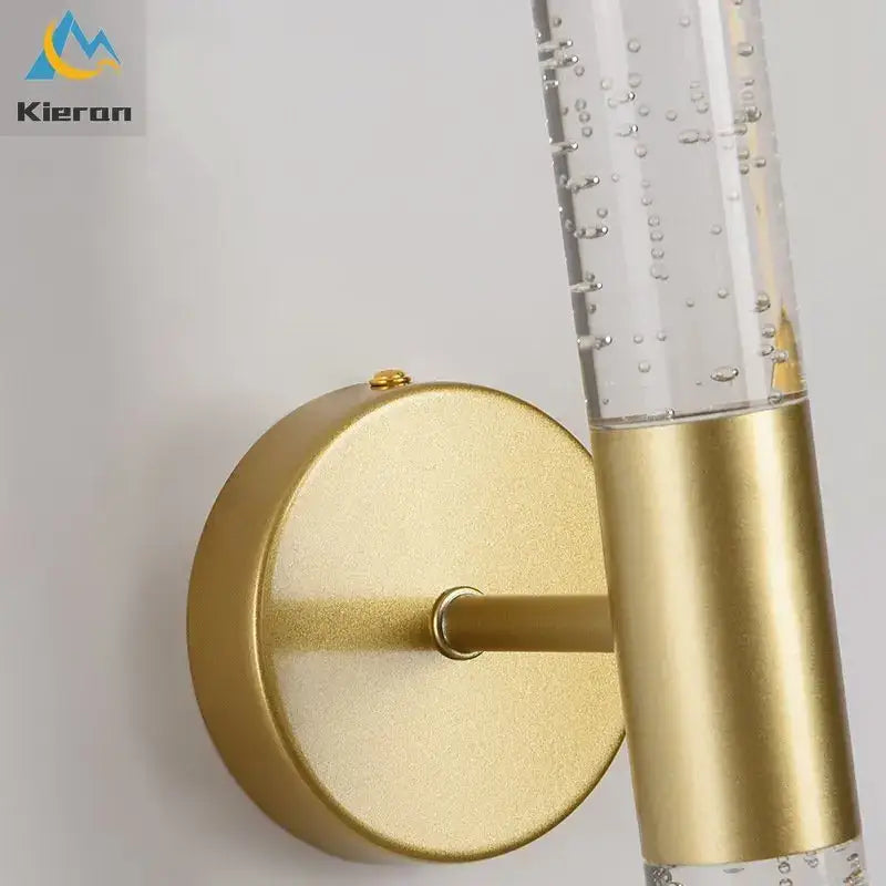 Gold-toned decorbites crystal led wall lamp with clear glass cylinder and floating bubbles for elegant bedroom decor