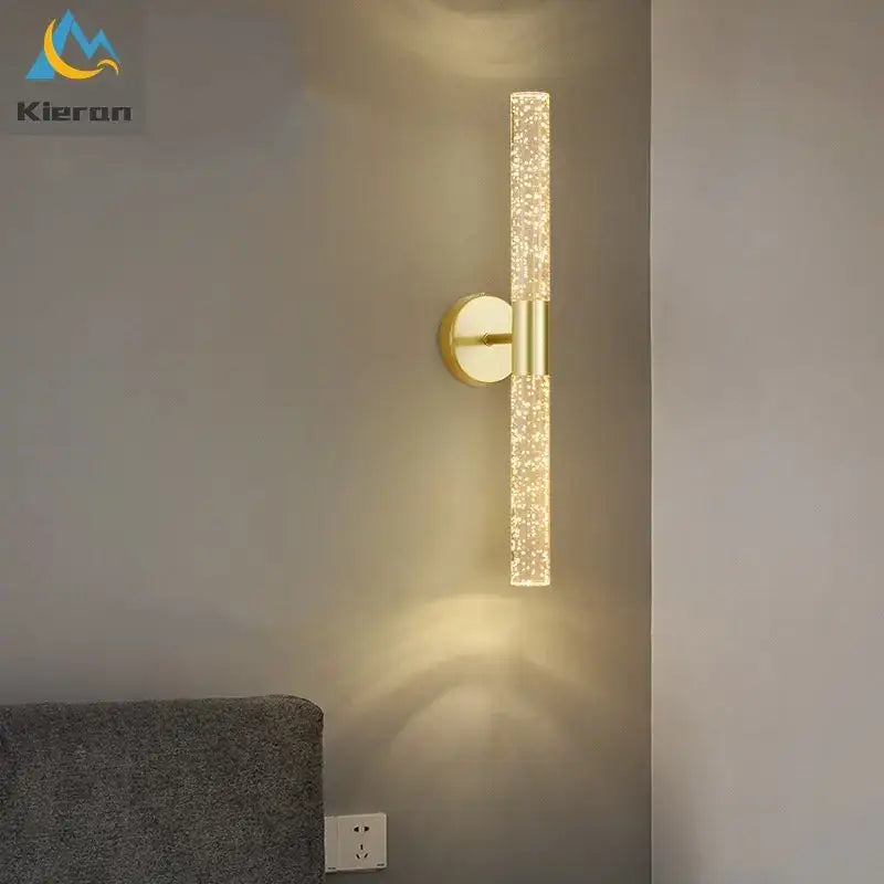 Gold-toned decorbites crystal led wall lamp with sparkling textured glass cylinder emitting warm light for bedroom decor