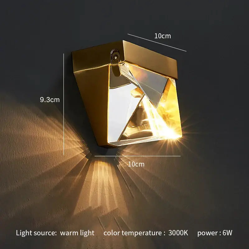 Modern gold crystal led wall sconce with geometric design and mirrored facets casting warm light for bedroom decorbites crystal led wall