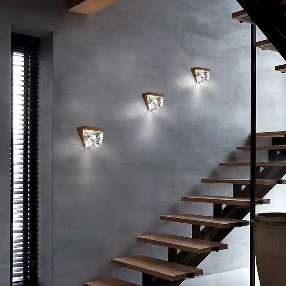 Three modern gold decorbites crystal led wall sconces with triangular wooden bases and faceted crystal led shades for bedroom decor