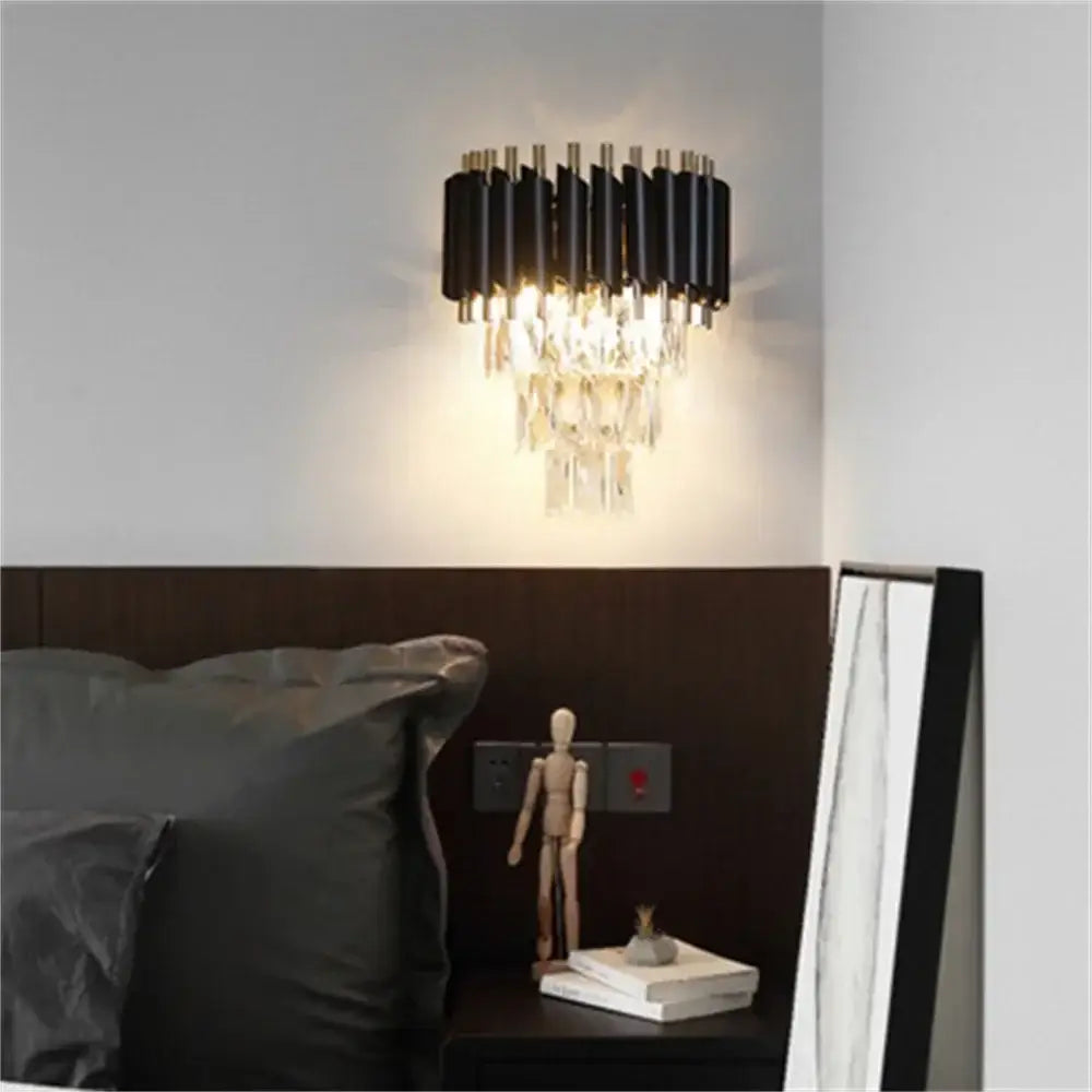 Modern black led wall sconces with gold finish and cascading crystal accents for bedroom lighting