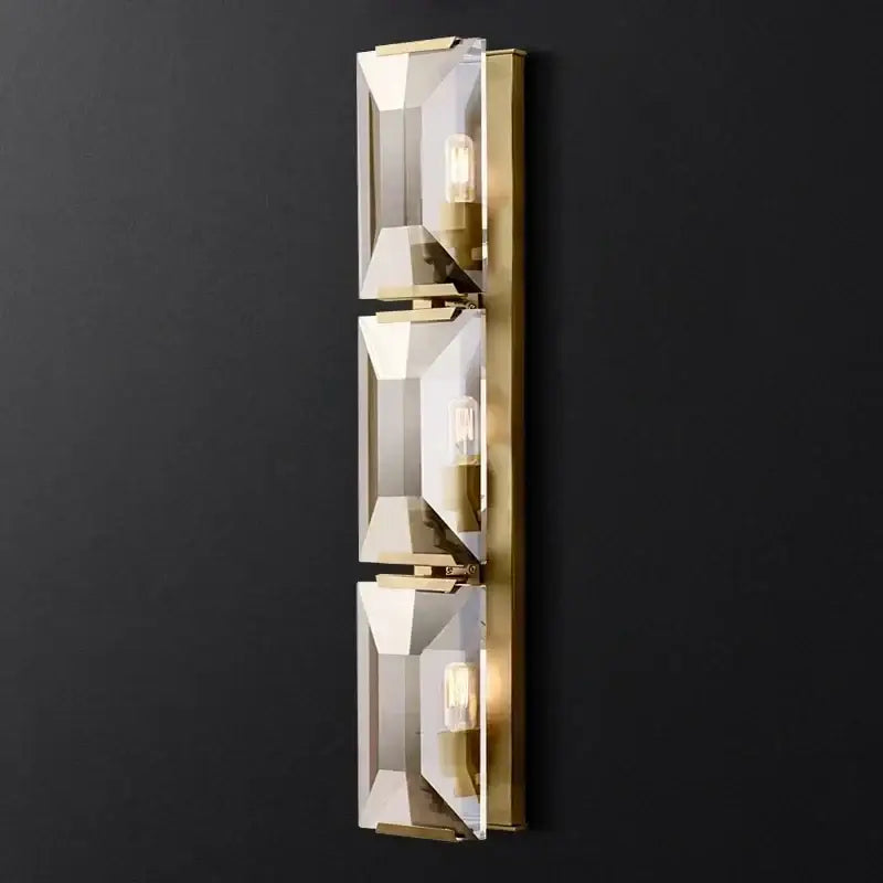 Gold-toned wall sconces with three vertical faceted crystal led panels and exposed bulb sockets for modern decorbites crystal led wall lighting