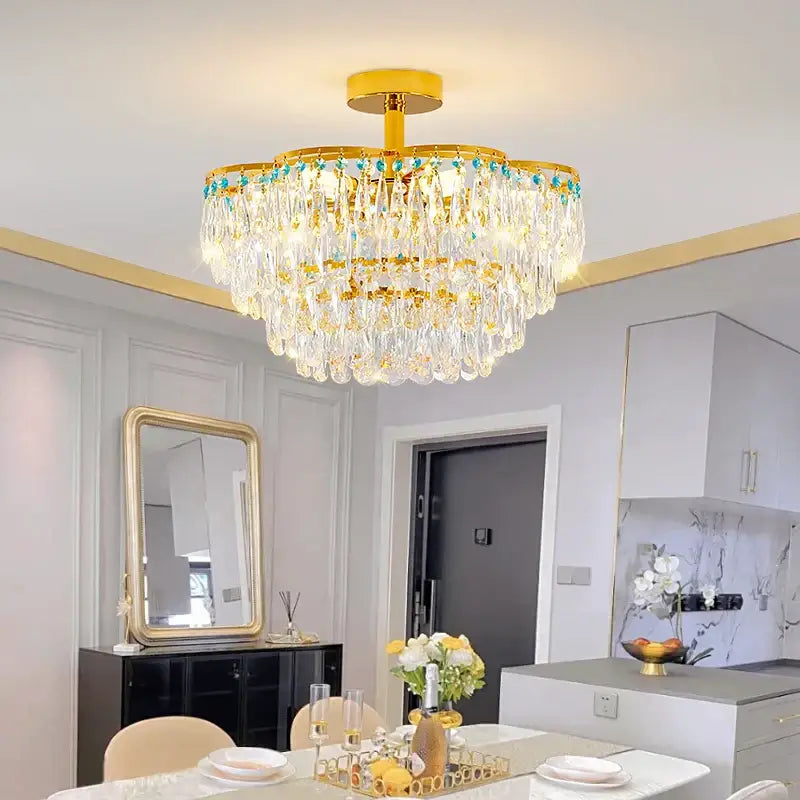 A multi-tiered post-modern gold and turquoise crystal light chandelier with gemstone details for dining room decorbites crystal light
