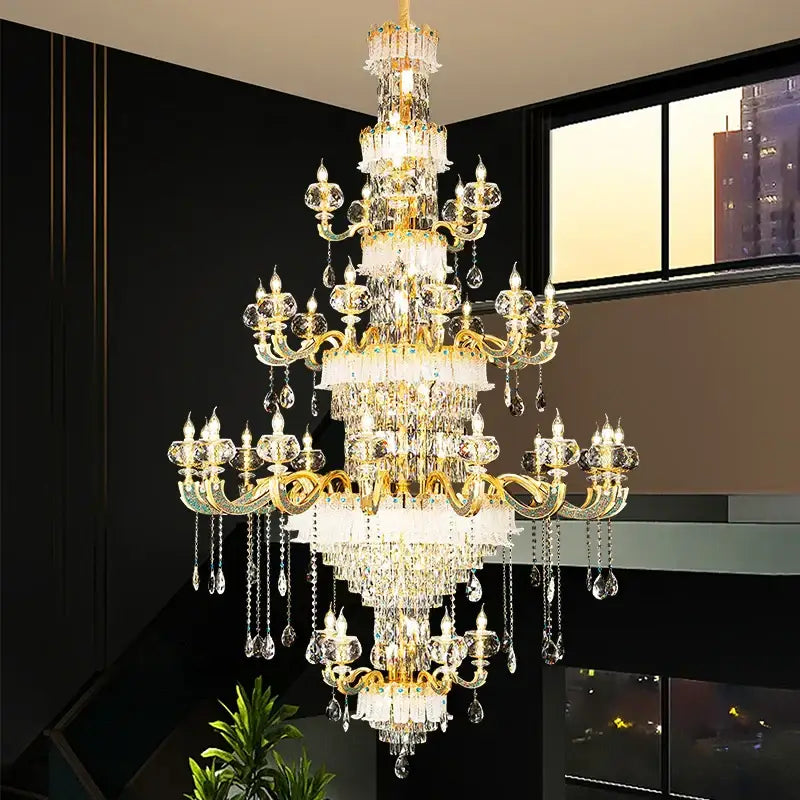 Grand multi tier gold crystal chandelier with ornate arms and droplets for elegant crystal living room decor