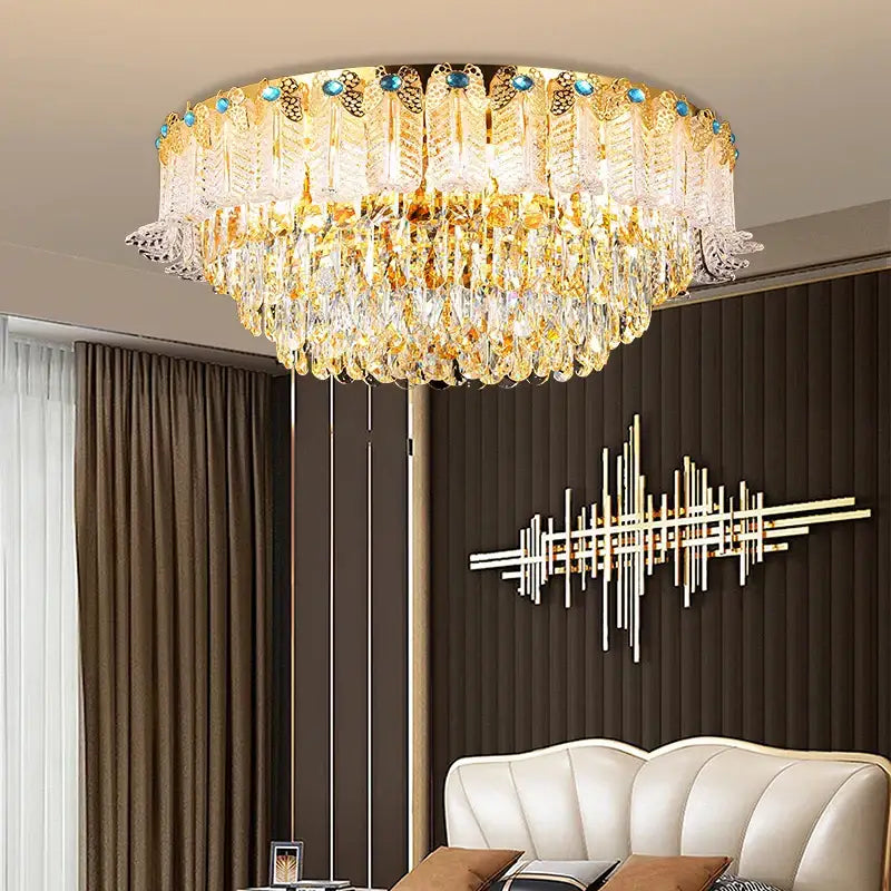 Grand multi tier gold crystal chandelier with feather designs and blue gemstones for elegant crystal living room decor