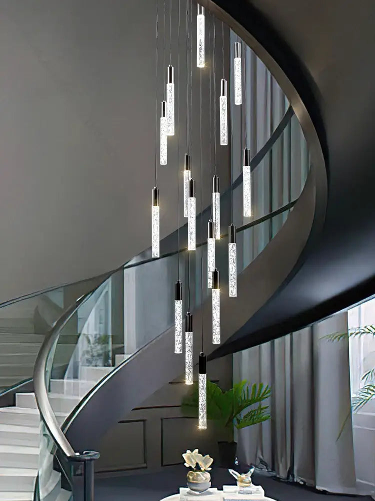 A modern silver and black crystal living room hotel chandelier with cylindrical glass pendants and sparkling crystal interiors