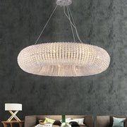 A modern crystal loft chandelier with a silver-toned ring of clear crystal beads for elegant living room decorbites lighting