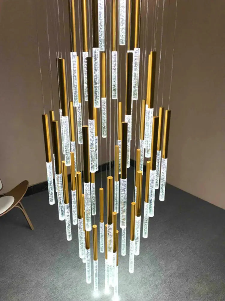 A decorbites crystal loft gold and clear chandelier with vertical polished gold rods and embedded led lights for living rooms
