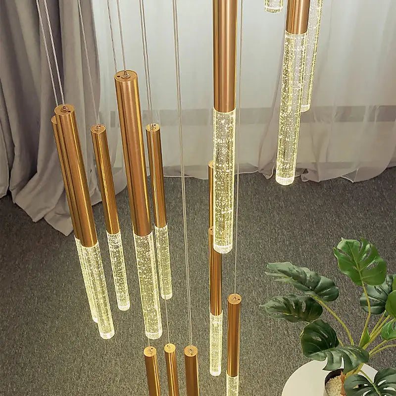 Modern gold-toned cylindrical pendant lights with clear glass and led illumination in decorbites crystal loft chandelier