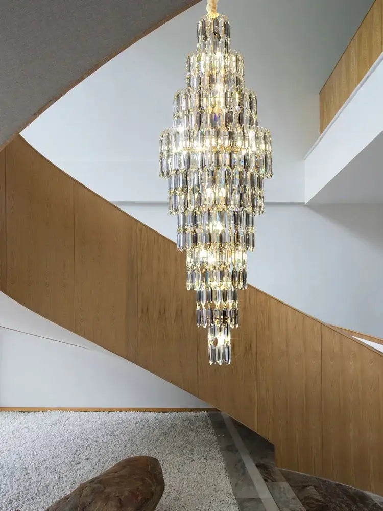 A multi-tiered crystal spiral loft pendant light with clear and gold glass elements for staircase and living room