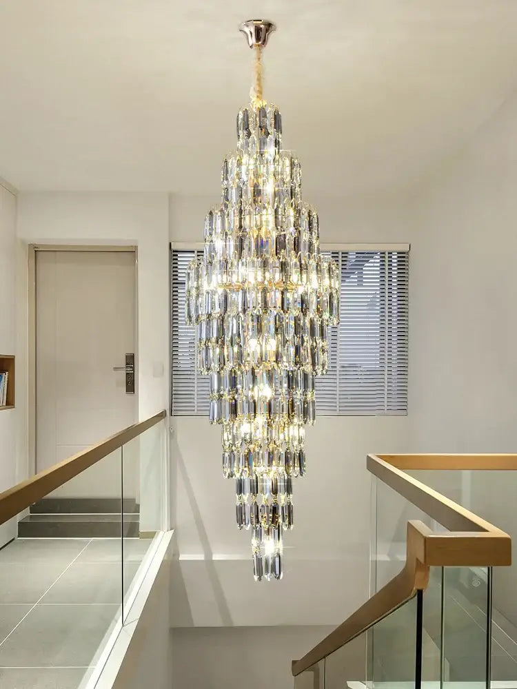 Crystal spiral tiered loft pendant light with polished brass finish and cascading glass prisms for staircase and living room