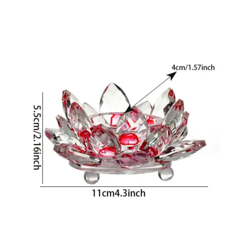 A clear crystal lotus candle holder with red gemstone accents and three rounded feet for dining room aromatherapy use