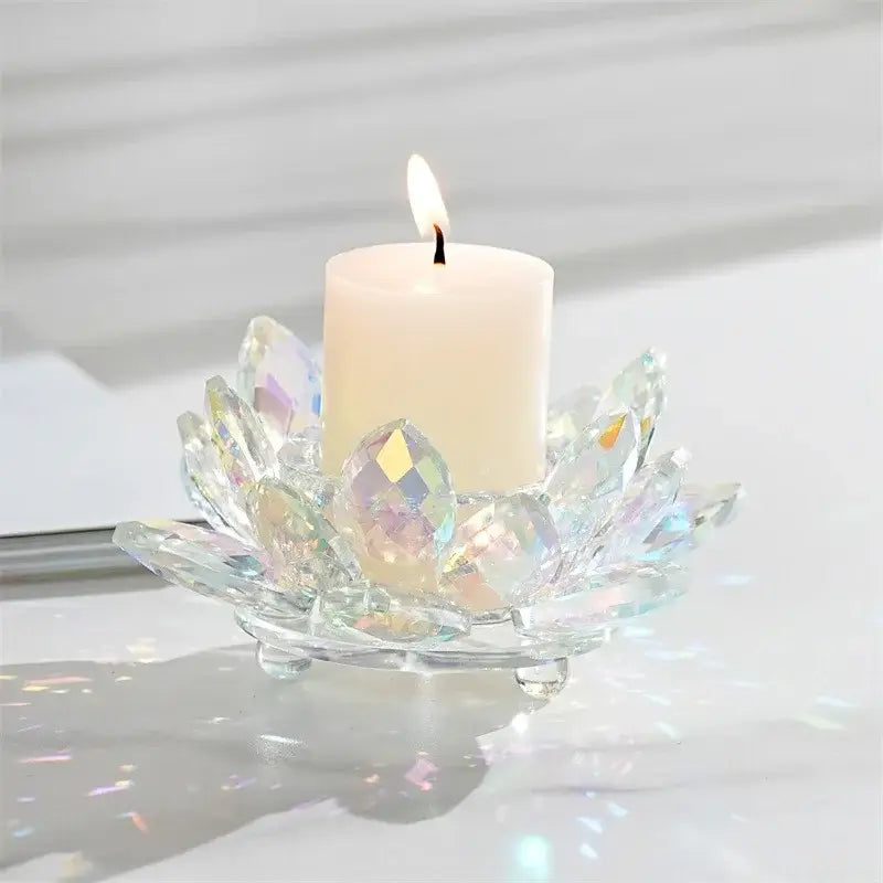 A clear faceted crystal lotus candle holder with a white pillar candle for colorful aromatherapy use