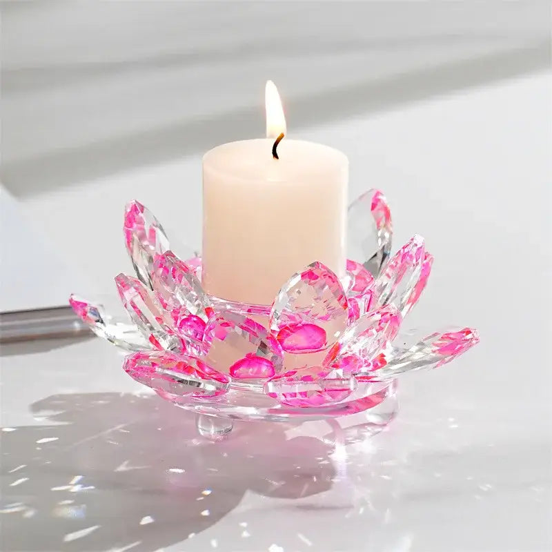 Translucent pink and clear crystal lotus candle holder with faceted petals cradling a white pillar candle for aromatherapy