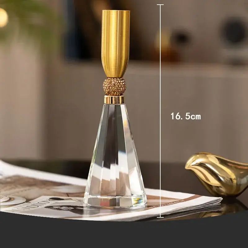 Elegant gold and crystal lotus candle holder with faceted base and beaded metallic top for dining room decor