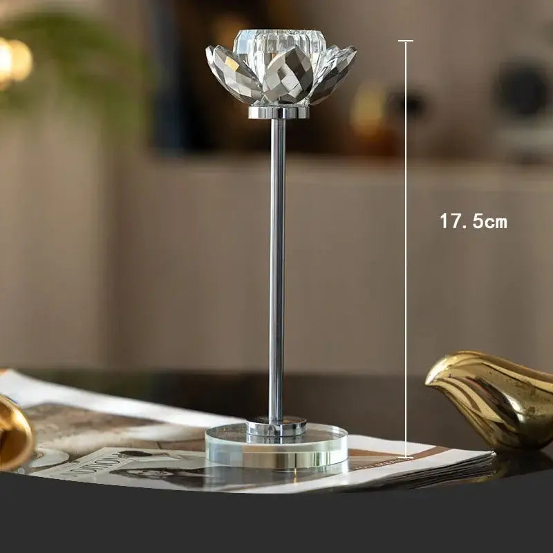 Elegant clear crystal lotus candle holder with faceted design and sleek chrome base for dining room decor