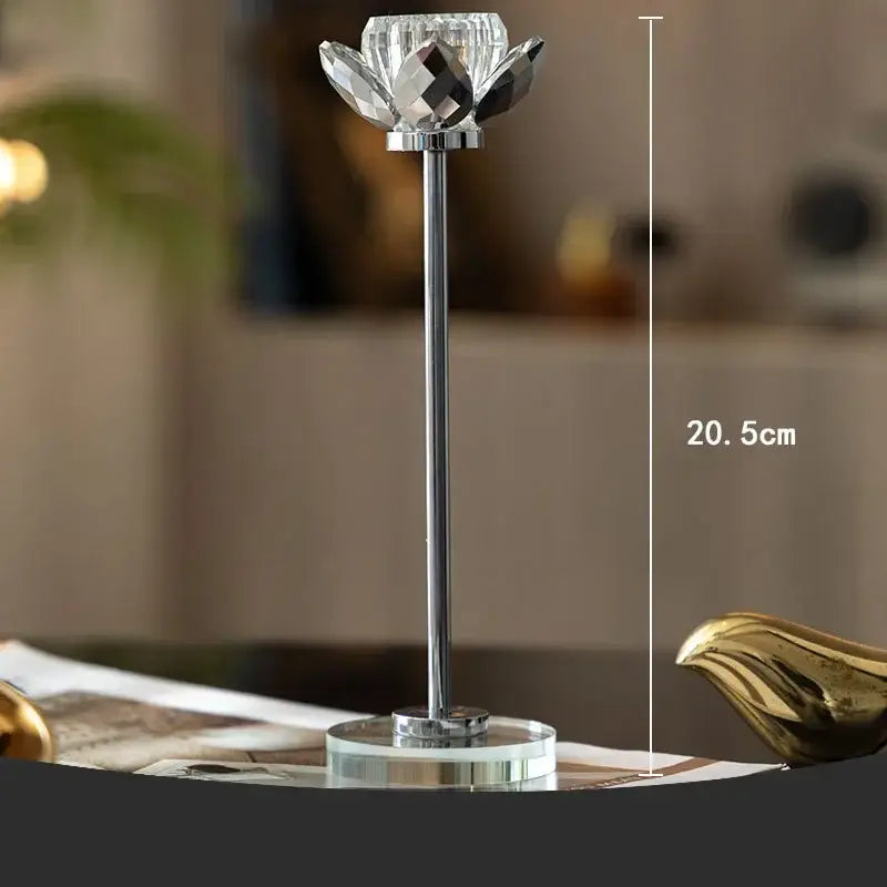 Elegant gold and crystal lotus candle holder with a sleek chrome stem and base for dining room decor