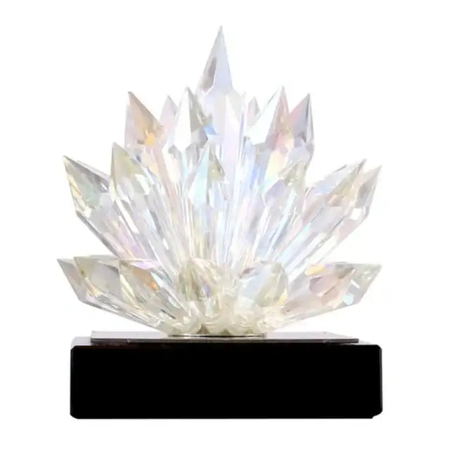 A translucent faceted crystal lotus tabletop decoration with a sparkling design on a sleek black base by decorbites