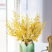 Mint green ceramic vase with gold rim holding a lemon grass branch arrangement for living room decor