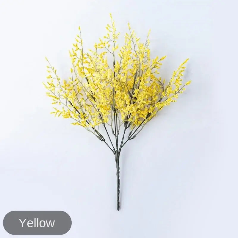 Mint green ceramic vase with vibrant yellow artificial lemon grass branch and slender dark stems for living room decor