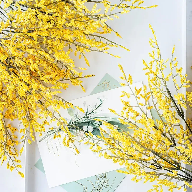 Mint green ceramic vase with a vibrant yellow crystal lover lemon grass branch for living room decor
