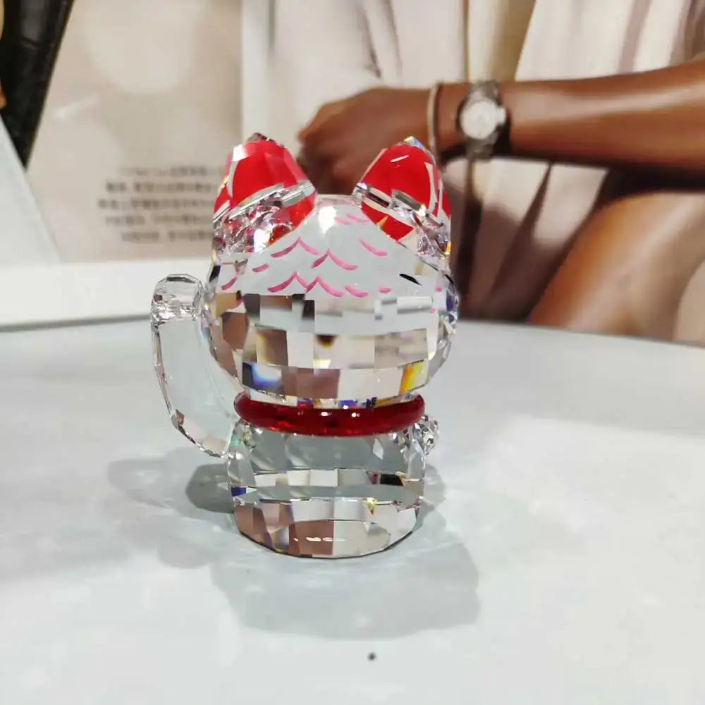 A sparkling crystal lucky cat figurine with red accents and glossy finish for living room decor