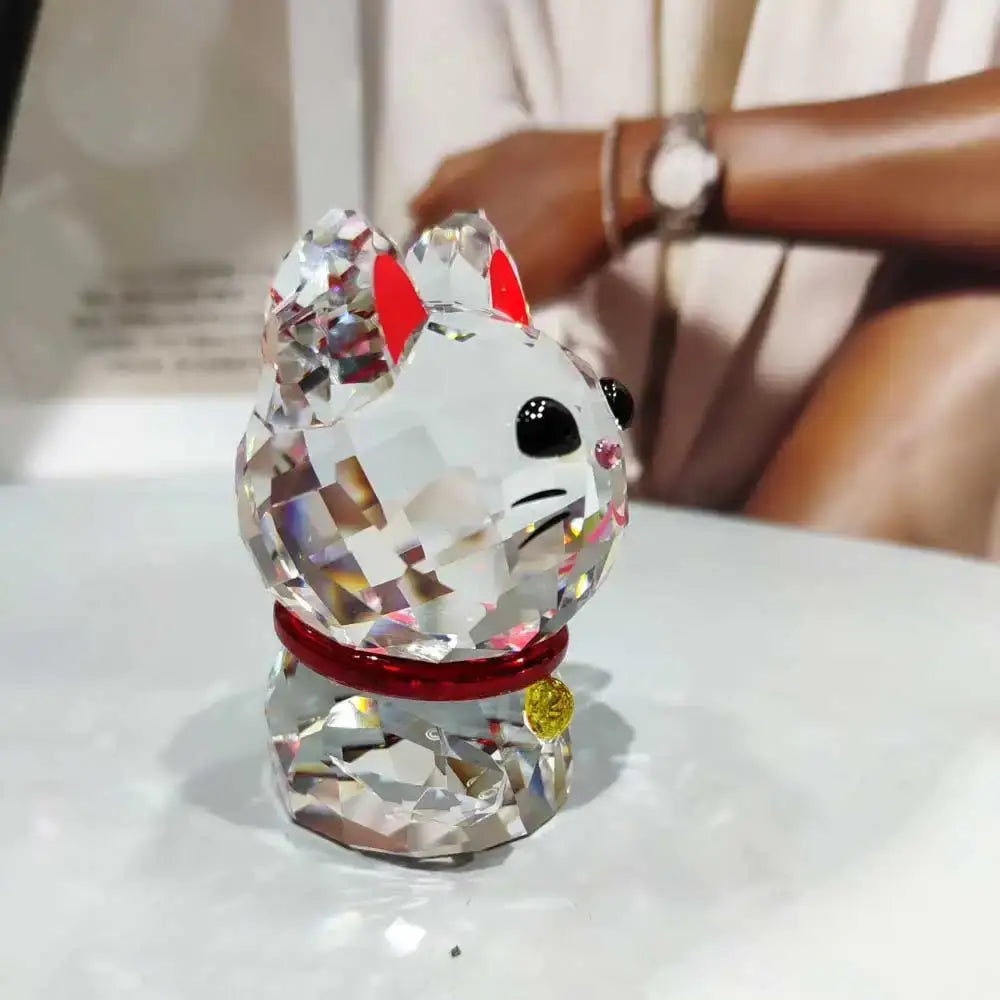 A faceted crystal lucky cat figurine with red accents and a gold bell for living room decor in swarovski style