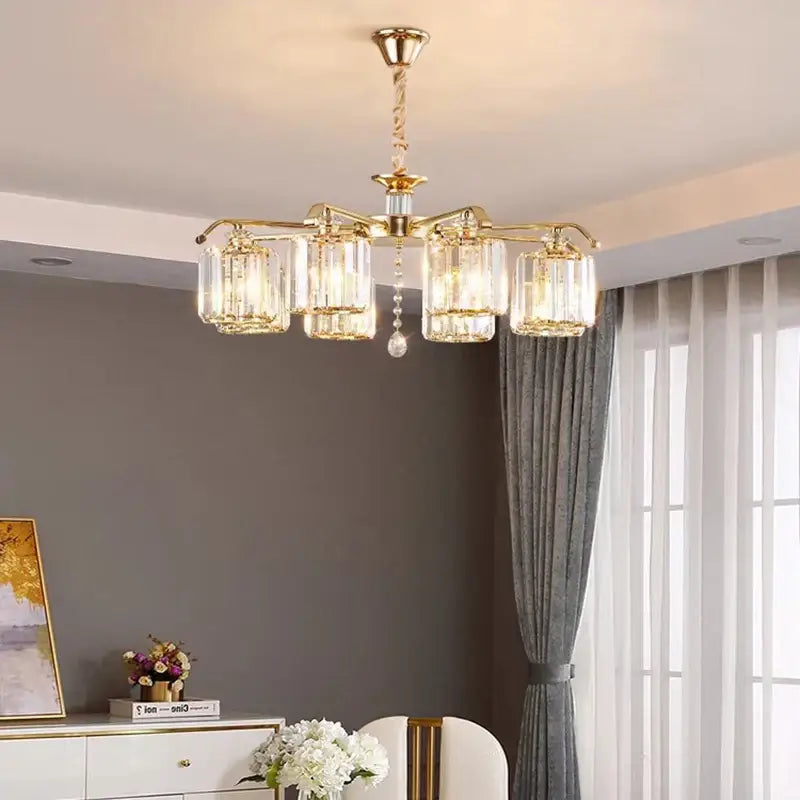 Modern gold crystal lustre chandelier featuring five clear glass candle-style shades and a central crystal drop for luxury decorbites lighting