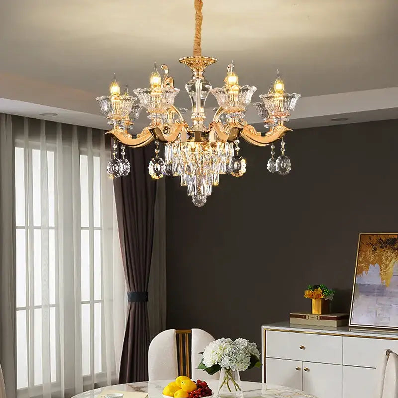 Elegant european gold crystal luxe pendant lamp with gold-toned chandelier and crystal glass arms for dining room