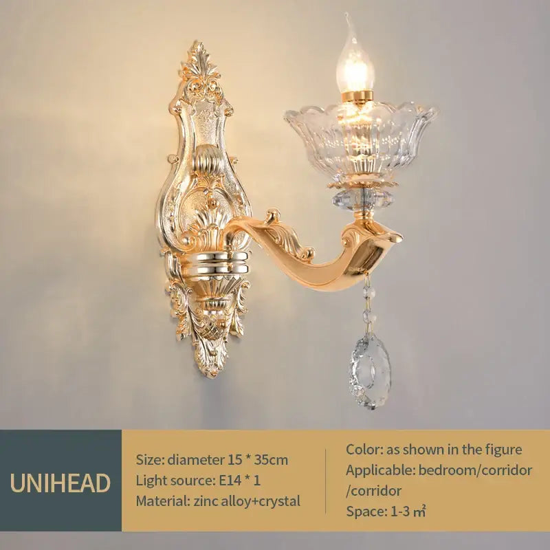 Ornate gold-toned European crystal luxe pendant lamp with crystal glass shade and dangling droplet for dining room