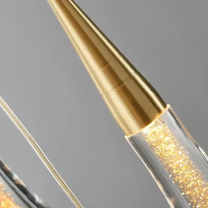 Modern gold crystal luxury ceiling chandelier with gold-toned conical lampshade and clear glass body with swirling glitter