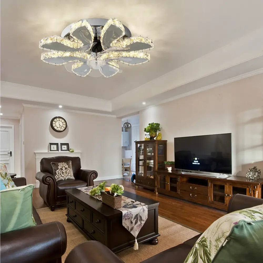 Modern crystal luxury ceiling fan with gold and chrome floral design featuring clear elements emitting warm light