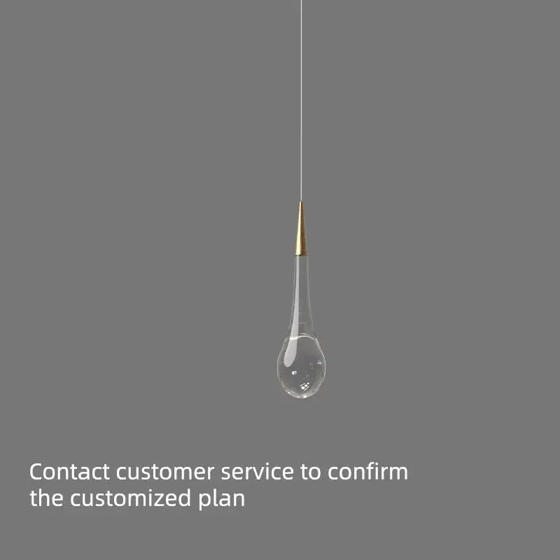 A sleek teardrop-shaped decorbites crystal luxury chandelier with clear glass and gold-toned top for dining rooms and lobbies