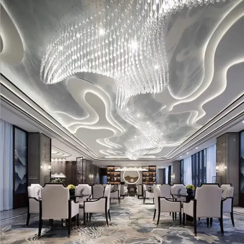 A large decorbites crystal luxury chandelier with intricate cascading droplets hangs from a modern ceiling for dining rooms and hotel lobbies