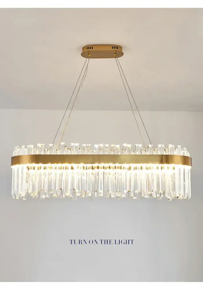 Gold-toned DecorBites™ crystal pendant chandelier with cascading clear prisms for luxury modest crystal home decor