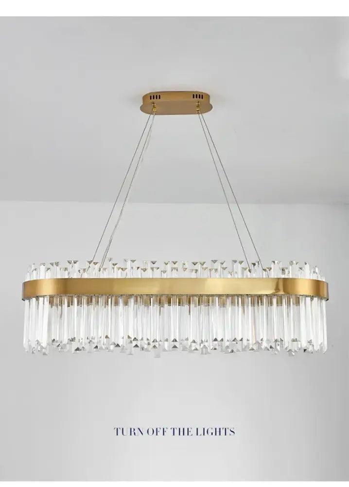 Gold-toned DecorBites™ oval chandelier with clear crystal prisms on sleek metal frame for luxury modest crystal home decor